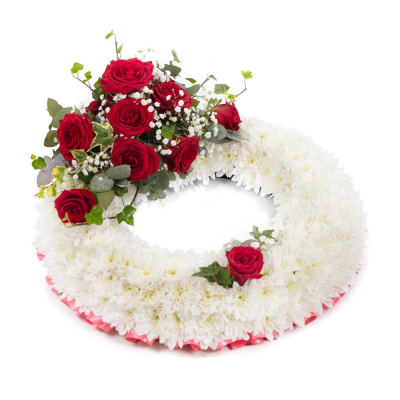 Wreath SYM-314 - This white massed wreath is finished with a red rose spray for an extra special tribute.
